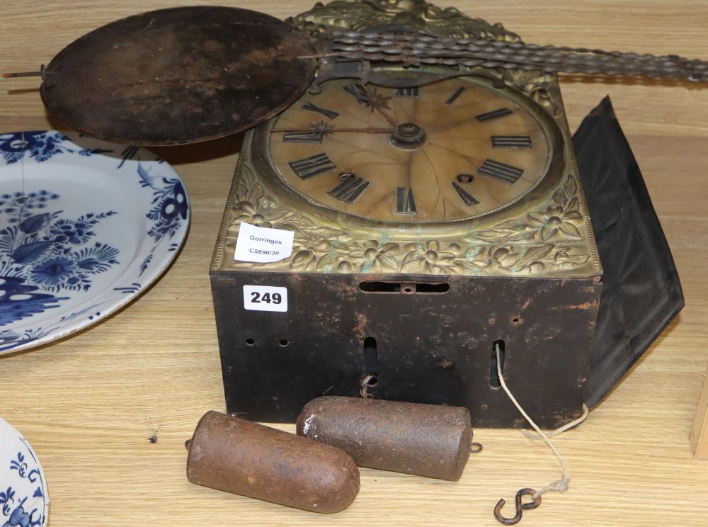 An early 19th century French wall clock, with an alabaster face and ebonised brass surround, above a long pendulum